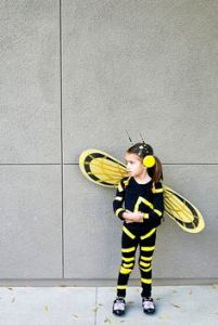 It's a little girl who's dressed like Wasp from the original Avengers. She's not the Avengers movie. But she's in Ant-Man. Also, she can fly as well as shrink, too.