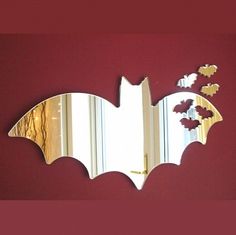 It's a mirror that's shaped like a bat and has other bats on it. Nevertheless, you can't help but like it.