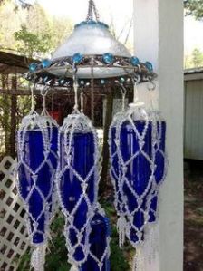 Kind of resembles a flying saucers with large bottles attached in a bead mesh. But it's a wind chime and a rather large one at that.