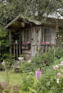 Yes, it looks as if it's an abandoned shack in a garden. Well, if it weren't for the blooming flowers.