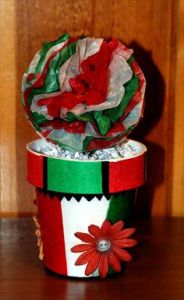 This is a painted flower pot in Mexican flag colors. Like the tissue paper flower on the top.