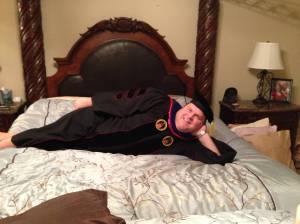 I think this might be someone's dad in his kid's cap and gown. And it's probably done as a joke. Pretty funny.