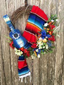 This one seems more simpler than the other wreaths. Maybe because it uses a serape, a guitar, and some floral decor.