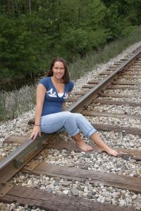 Who shouldn't be posing for a picture there because a train could freaking hit and run her over at any second. Jesus, doesn't she ever have a clue?