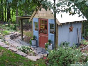 Well, this shed looks as colorful as it is rustic. Love the roof and the stonework outside.