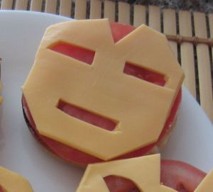 The cheese has Iron Man's face on it. The tomato is for background. Bound to do Stark Industries proud.