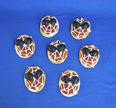 These are covered with tomato sauce, cheese, and olives. Brought to you by your friendly neighborhood Spider Man.