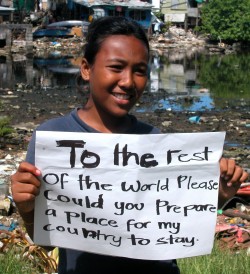 As sea levels rise, the existence of entire island nations are increasingly in jeopardy. This Pacific Islander is holding as sign asking the rest of the world to prepare a place where her country can stay. To some, climate change might mean losing a way of life or a home. To this girl, it means losing a country and everything with it.