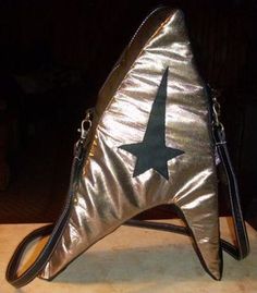Yes, this is a Starfleet purse since it has the logo. Not sure how much it could fit. But I do like the shiny gold color.