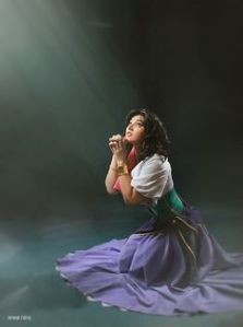 Here she's praying to God for the outcasts. Yet, in the movie, she's also one herself. And it's too bad Frollo is lusting after her which is creepy.