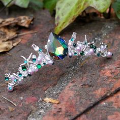 As you look at the forks near the large jewel. And the fact that it uses green stones.