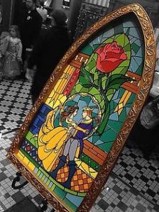 It's the stained glass window of Belle and the Prince at the end of Beauty and the Beast. And yes, the rose is prominently featured.