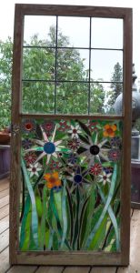 This one uses glass pieces inside an old window frame. And I'm sure you'll be in awe of these glass flowers.