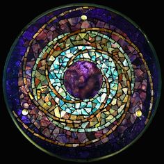 Of course, a lot of mosaics use geometric designs like the stained glass windows. But I like this one especially due to the purple center.