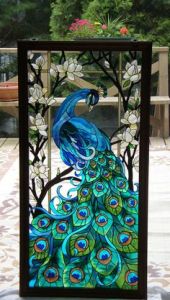 Yes, this is my second peacock stained glass panel. But this one has a more vivid tail. Love the feathers.