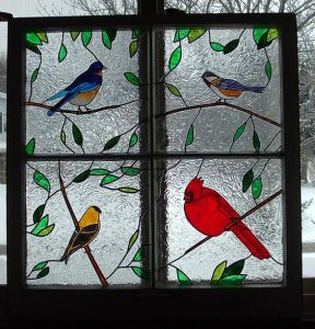 Consists of a Northern Bluebird, a Chickadee, a Goldfinch, and a Northern Cardinal. All these are North American birds.
