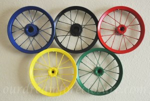 They're probably bike wheels without tires. But each is painted a different color and hung to a wall.