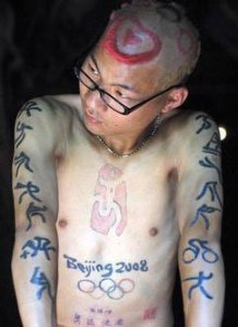 Because he's just a crazy Olympic fan to have such design on his chest forever. I know it's nuts but it's his choice.