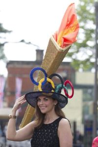 Now that's a really big hat with a really big torch. Not sure if I'd want to sit near someone like her.