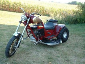 Yes, this is a motorcycle riding mower. It's part motorcycle, part tractor. Probably some kind of project in some guy's garage.