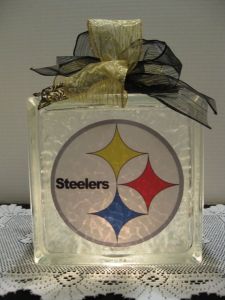 Just an old window glass block with a light bulb in it to spread out the light. Is topped off with a black and gold ribbon.