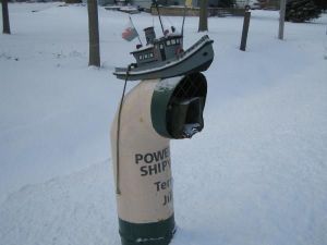 It's shaped like a submarine periscope with a boat on it. And it seems to be from Wales.