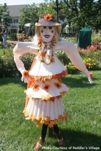 I mean her dress is made from 3 different lamp shades. And each one is trimmed with autumn leaves.