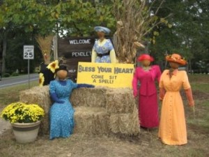I think this was for a town scarecrow contest. But I love how these ladies are wearing bright colored dresses. And how one of them sits on the hay bale.