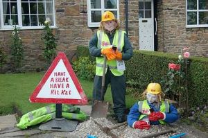 Yes, these are road workers. But the sign should clearly say, "Give me a break. Break me off a piece of that Kit Kat Bar." The slogan's wrong.