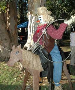 See he's on a wooden horse wearing a sheriff's badge. And he's carrying a lasso. Seems more like a rodeo clown to me.