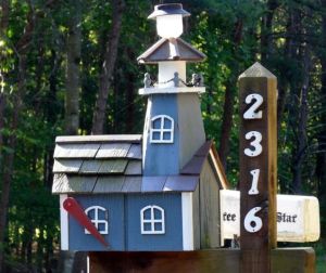 Yes, it's another lighthouse mailbox. But this one is made from wood, painted, blue and much smaller than the other one.
