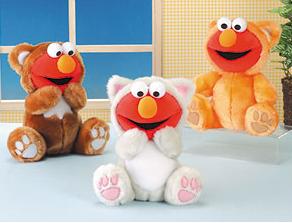 From Tough Pigs: "Elmo had so much fun at the furry convention, he went back the next year. So, from left to right, Elmo is a bear, a cat, and... another cat?"