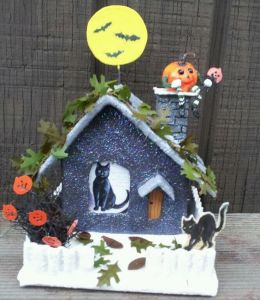 This one has a black cat inside as well as a pumpkin on the chimney. Not sure about the snow though.