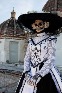 This is fairly close to a traditional Catrina which was a figure of Mexican satire on the upper class. And yes, she dressed like the Dowager Countess from Downton Abbey.