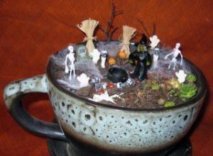 I don't think the teacup is necessarily little. But I love how it's shaded to fit with the Halloween decor on this.