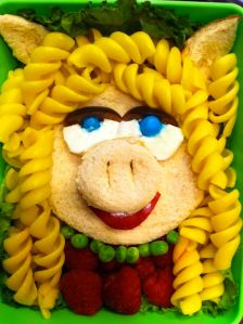 It consists of a sandwich with pasta hair. Also bread ears and snout. But it surely resembles her.