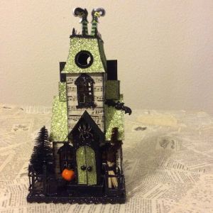 The green house seems to have a lovely glitter roof and door. Yet, the feet sticking out is quite funny.