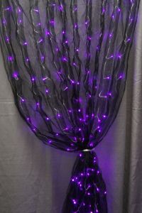 Well, the lights are purple. But ti certainly gives a scary impression. Goes well with the lit spider wreath.