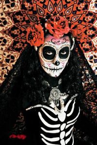Well, she's dressed in a skeletal outfit. But she has the skull face, flowers, and veil for Dia de los Muertos.
