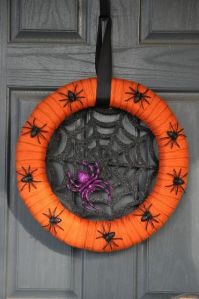 Another wreath to freak out arachnaphobes. Too bad the purple spider hogs the web from the black ones.