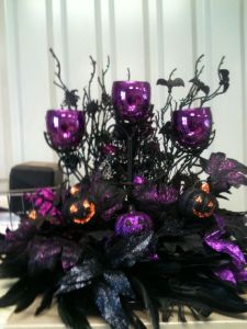 Yes, it's another Halloween candle display. But this has feathers and pumpkins. Love the purple holders.