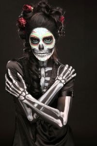 Well, she has a lot of skeleton makeup on her. Yet she has a black dress on to, if you look closer.
