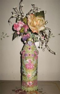 Okay, the flowers are fake and the bottle is covered in cloth. But it might look great on a mantle or table.