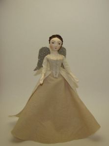 Surely she's a demure beauty of heaven above. Yet, she wears a plain dress and doesn't illuminate.