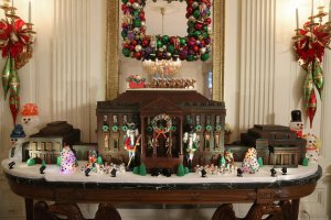 Caption: "WASHINGTON, DC - DECEMBER 02: A chocolate gingerbread house is on display in the State Dining Room during first lady Michelle Obama's preview of the 2015 holiday decor at the White House December 2, 2015 in Washington, DC. As part of the Joining Forces initiative, the first lady welcomed military families to the White House for the first viewing of the 2015 holiday decorations." To be fair, a gingerbread White House is kind of a holiday tradition since the Carter Administration.