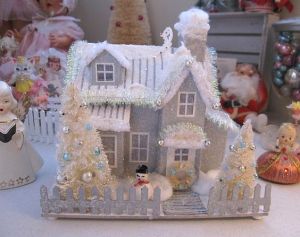 This one has silver trimming on the roof. Whether it's to express snow or decoration, I'm not sure. Like how the smoke comes from the chimney though.