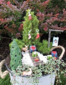 This one has stockings hung at the tree as well as gifts on a sled nearby. There is even a deer in the snow.