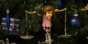 I'm not sure how to feel about this. On one hand, she seems to have a scale on her shoulder and is riding a tricycle, which might mean she's under torture. On the other hand, it might symbolize her authority which would make me cringe.