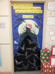 This is a door decoration for a school. Kids write on the bats. Not sure about Batman in a Santa hat.