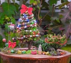 Both tree and shrub seem to have a lot of beads on it. The lights also look pretty.